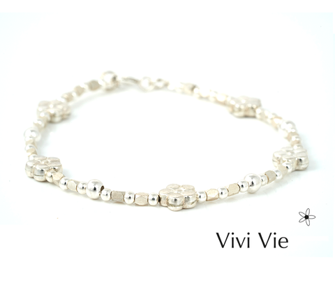 Silver flowers  braclet made to last. A flower whispers sunshine, food, and medicine for the soul.