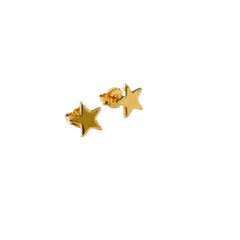 Gold star earrings on a white jewelry box