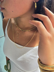 Gold disk necklace.