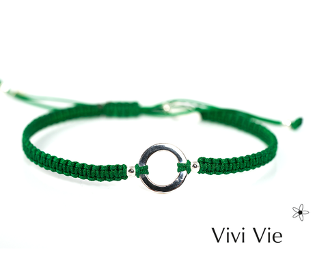 Sterling Sliver circle braclet on a green adjustable extender style cord.