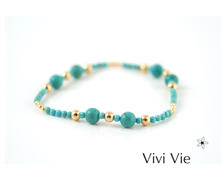 The turququoise capri braclet turquoise with a golden accent.