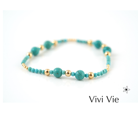 The turququoise capri braclet turquoise with a golden accent.