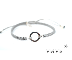 Silver circle karma frienship braclet on  a silver grey  colour  cord.