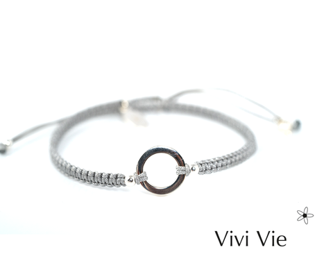 Silver circle karma frienship braclet on  a silver grey  colour  cord.