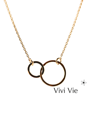 Minimalist intelocking gold double  circle necklace.The two inerlocking circles